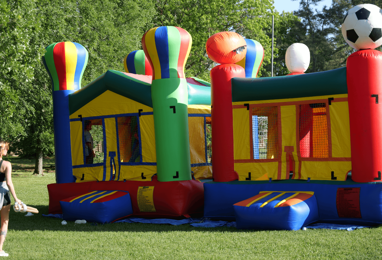 two bounce houses in the grass
