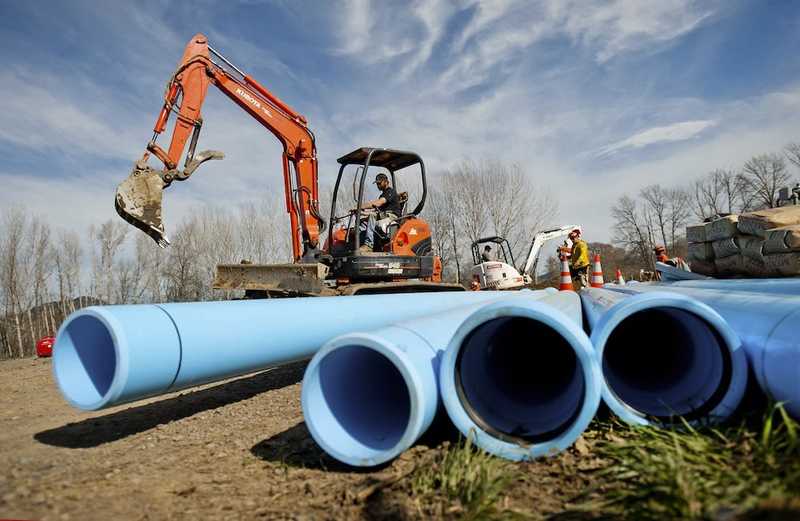 several large blue pipes moved into staging yard