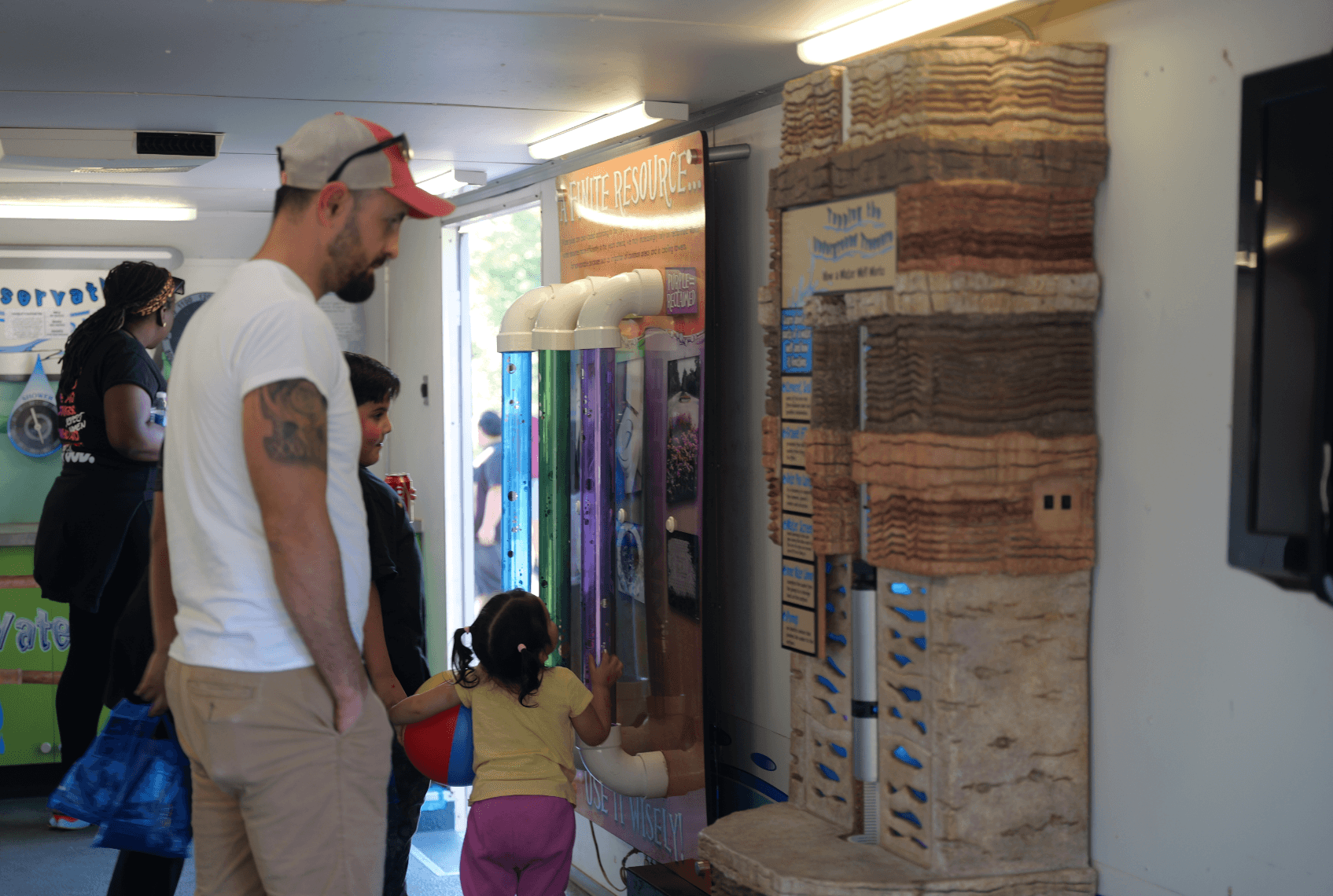people viewing exhibits in a trailer